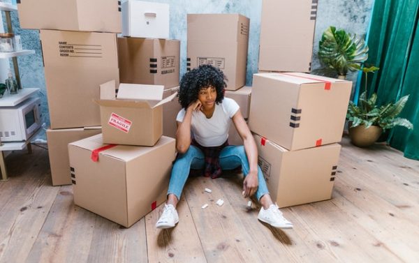 woman sitting in between packages