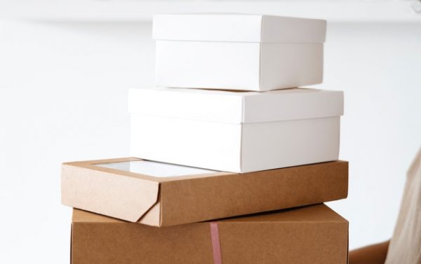 pile of packaging boxes held by a woman